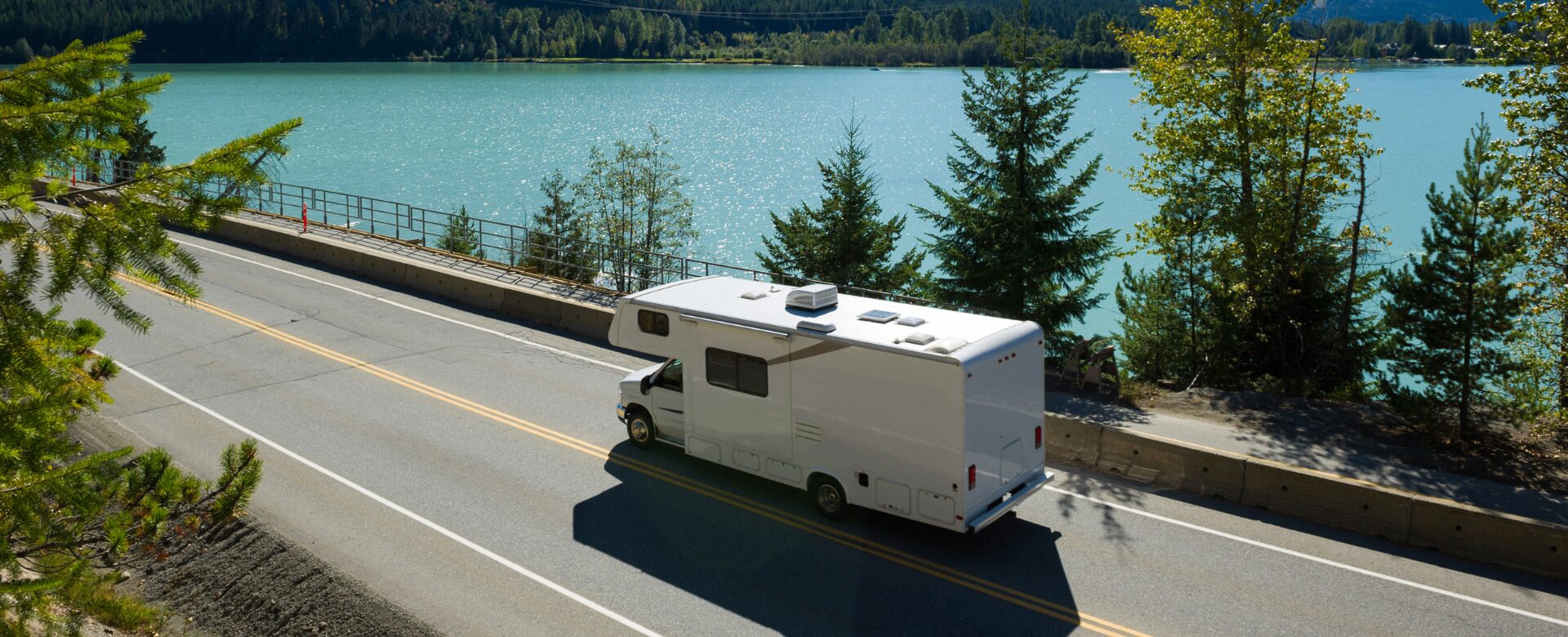 An RV parked beside a quiet South Dakota lake at sunrise